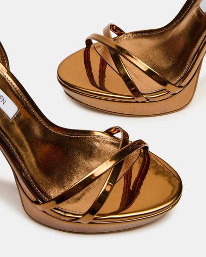 JUNI Bronze Criss Cross Stiletto Ankle Strap Women's Heel | Steve Madden